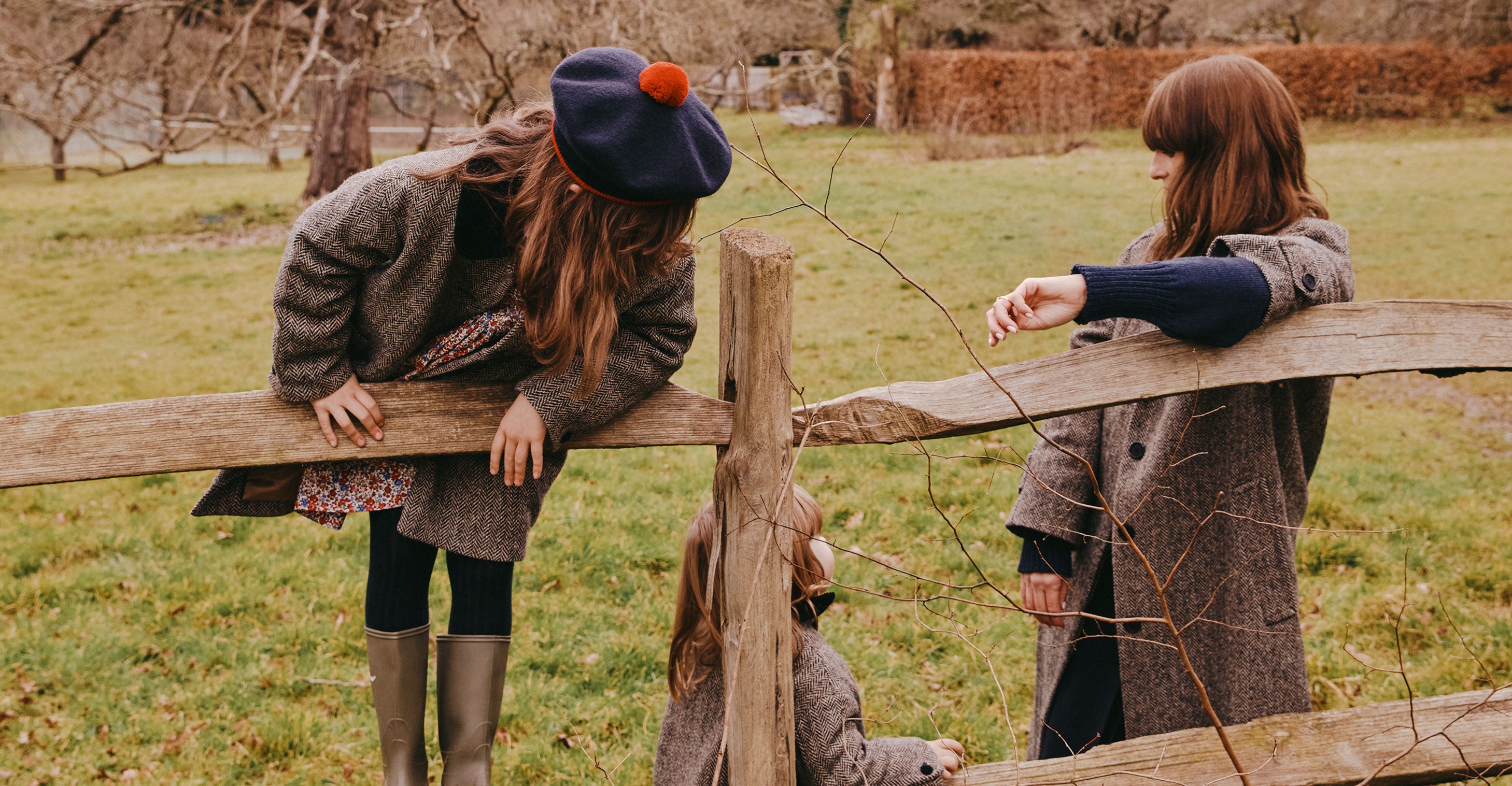 British collection page cover photo of three girls standing near fences